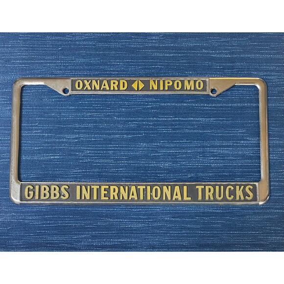 Vtg Oxnard Nipomo CA Gibbs International Trucks Metal Dealer License Plate Frame